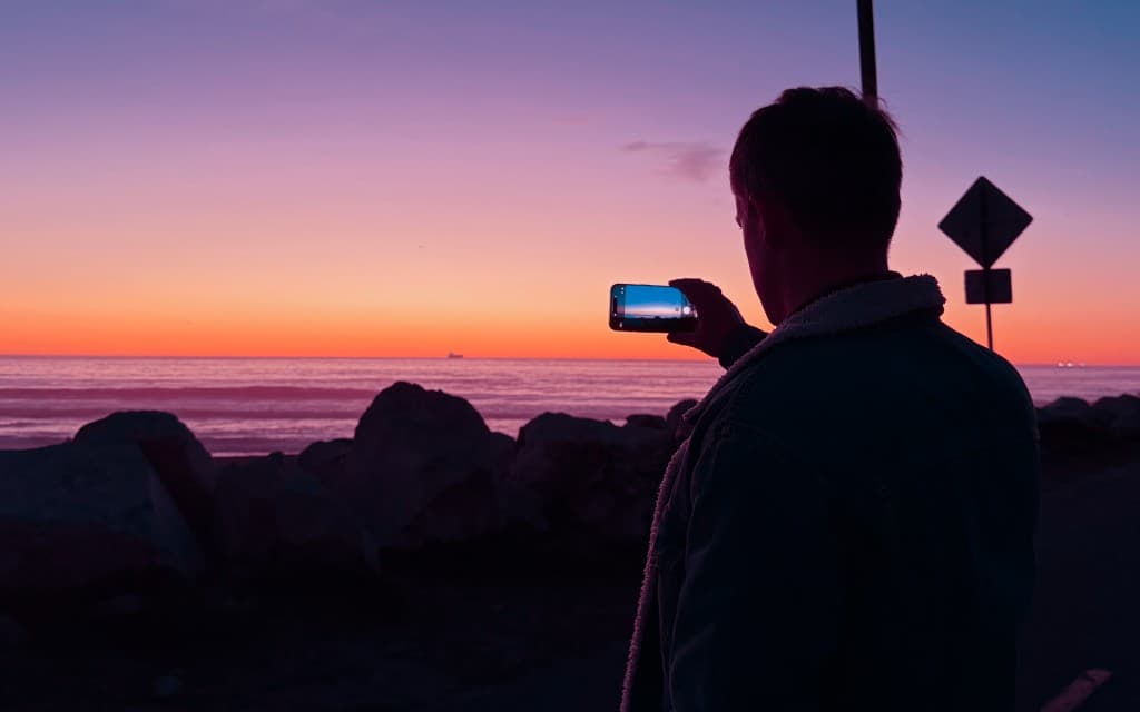 Phil, photographing the sunset over the Pacific from the San Diego coast